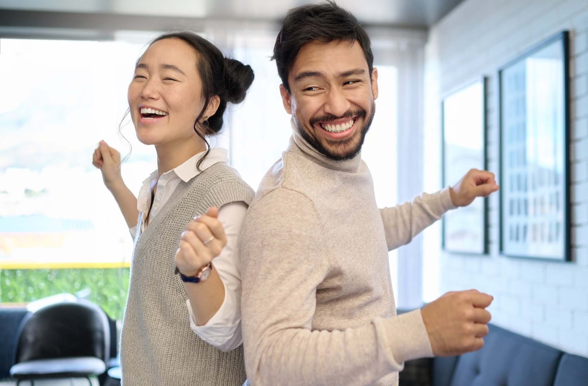 Couple, love and dance in home living room, having fun and laughing while enjoying time together. Music freedom, diversity and interracial man and woman dancing, smile and bonding in lovely house